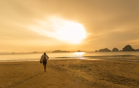 Man walking in a Beach at Dawnの写真素材