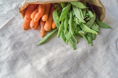 Bag full of beans and carrots from a ecologic orchard. Ecologic Bag. No plastic Bagの写真素材