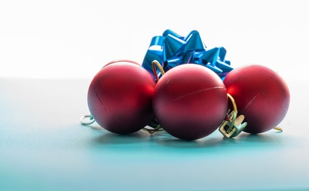 Red Christmas Balls and a blue Star over a beautiful blue backgroundの写真素材
