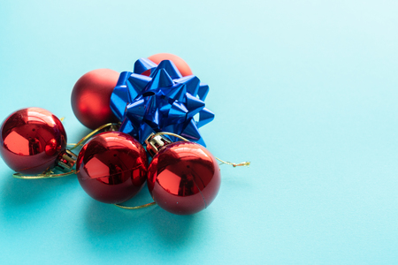 Red Christmas Balls and a blue Star over a beautiful blue backgroundの写真素材