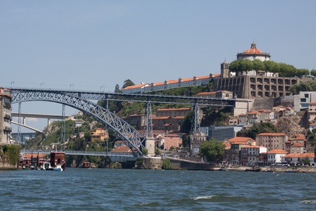 The Luis I bridge is a metal arch bridge that spans the Douro river between Porto and Vila Nova de Gaia. It was designed by a student of Eifel and has the same iron appearance as does the Parisian tower.の写真素材