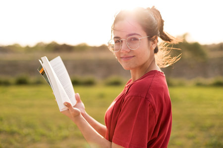 Young woman talking on her phone is making a surprise expression because of receiving bad news while...