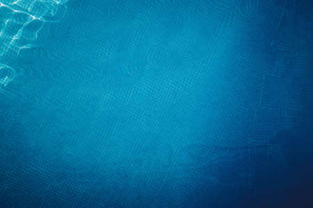 Top view of a swimming pool floor with blue tiled. Textured backgroundの写真素材