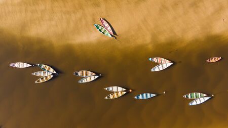 Color boats on a river from a drone view. bucolic feelings, peaceful atmosphereの写真素材