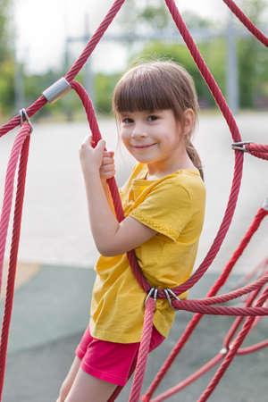 cute 6 years old girl on the playgroundの写真素材