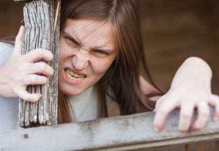 Horror monster smiles terribly and comes out of the holeの写真素材