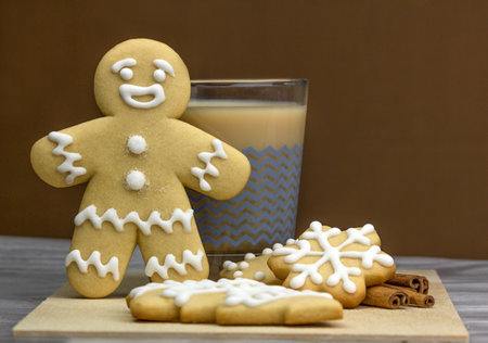 Gingerbread man with glass of cappuccino and cookies
