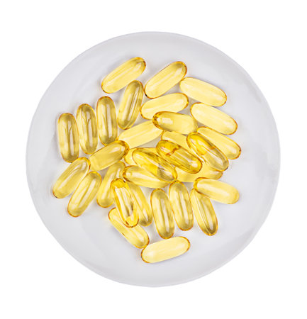 Heap pills of fish oil capsules isolated on white plate. top view.の写真素材