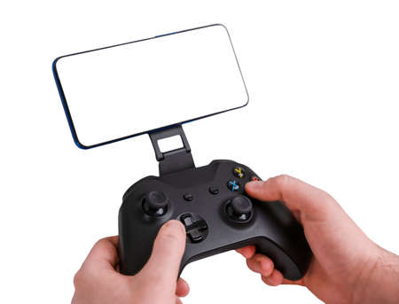 A man playing with a gamepad and smartphone. Hands holding gamepad isolated on white backgroundの写真素材