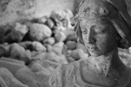 A monochrome plaster statue in a sculptorâs studio in Volterra, Italy.The statue looks like meditating about her origin, the stone.の写真素材
