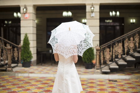 Bride putting on her white wedding dressの写真素材