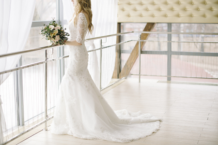 Beautiful wedding bouquet of flowers in hands of the brideの写真素材