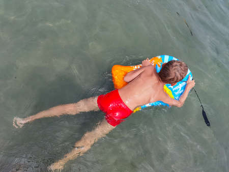 boy with phone in the water