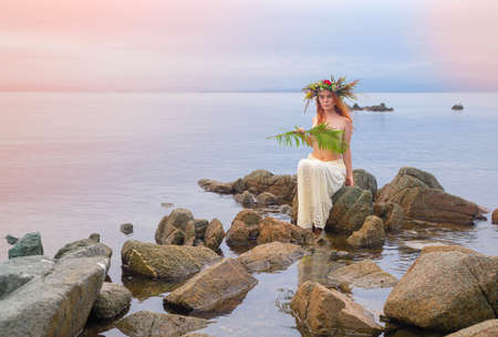 the girl in the wreath behind the seaの写真素材