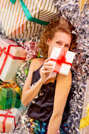 happy girl among gifts and tinsel
