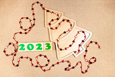2023 blocks brown background and wooden xmas tree