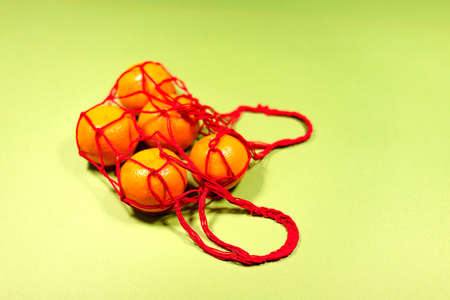 tangerines in a grid on a green background
