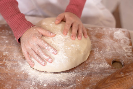 childrens hands on the dough