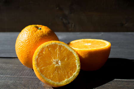 Fresh oranges on a dark wooden background. Copy space for text.の写真素材
