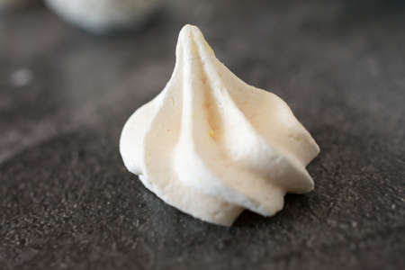White meringue on a dark background. Close-up.
