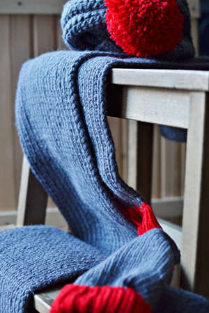 Woolen winter cloths on a wooden step stoolの写真素材