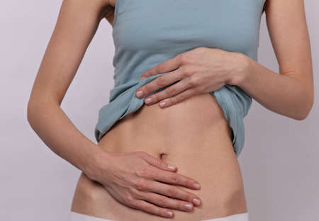 Woman suffering from stomach painの写真素材