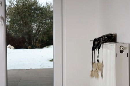 Heating radiator with warm clothes indoorの写真素材