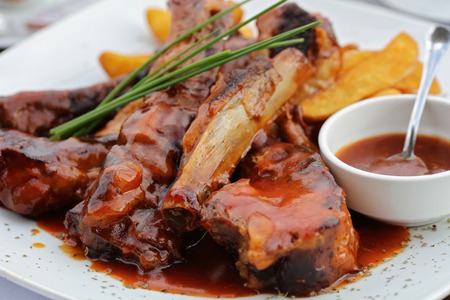 Roasted sliced pork ribs with barbecue sauceの写真素材