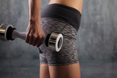 Finess Woman dumbbell workout at gym. Sport, weigt loss, active lifestyle conceptの写真素材