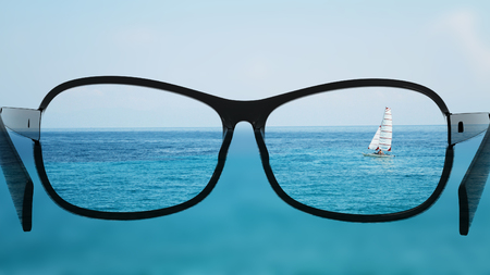 Put the glasses for the different, better view. Looking at the boat in the sea, ocean.の写真素材