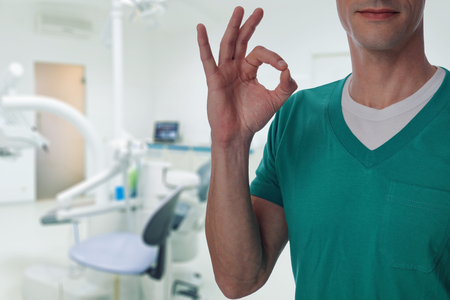 Male doctor dentist showing thumb up. Oral health care conceptの写真素材