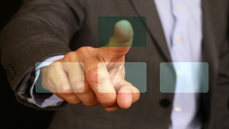 male businessman touch with the finger button on glass monitor, touch screen. Internet, technology, web business concept.の写真素材