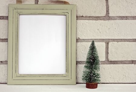 Christmas and New Year background. Empty picture frame, fir with with copy space blank tag on white background. Copy space image. Scandinavian style home interior decorationの写真素材