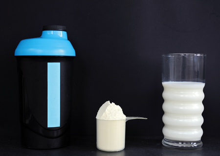 Bodybuilding suplements. Whey protein, milk and shaker Workout, training, Gym concept. Sport background.の写真素材