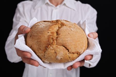 Man holding loaf of tasty fresh breadの写真素材