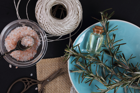 Still life photography. Sea salt, rosemary herb and olive oil on black backgroundの写真素材