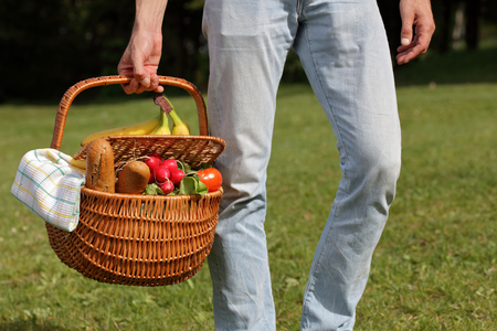 Man holding picnic basket in park .Lunch break outdoors ,Time for relax, Leisure Lifestyle Conceptの写真素材