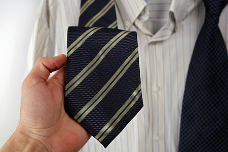Choosing a right tie for shirt from the closet. Formal business wear.の写真素材