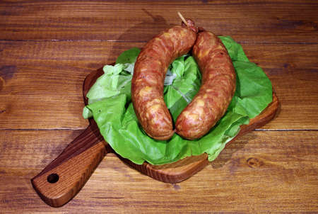 Raw homemade Kranjska sausages on wooden background