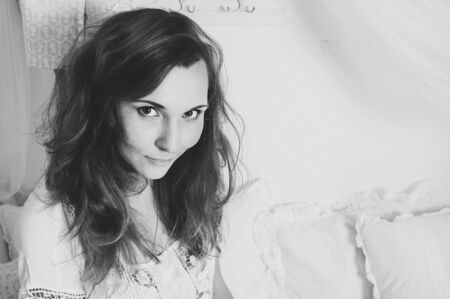 Black and white portrait of attractive young woman with sensual look in camera. Girl waiting for spring. Copy space. Space for textの写真素材