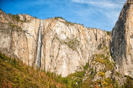 Scenic landscape with waterfall and rocks in Yosemite valley, Yosemite national park, California, USA. Travel tourism hiking destination. View of waterfall in sunny day.の写真素材