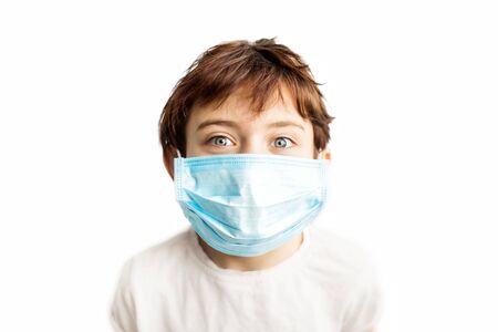 Child in blue medical mask on face. Prevention on first place. Coronavirus protection. Girl with face in mask. Children and illness. Medical care. Illness covid-2019 prevention.の写真素材