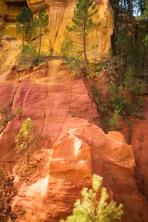 Vertical picture of ochre Trail in Roussillon, Sentier des Ocres, hiking path in natural colorful...