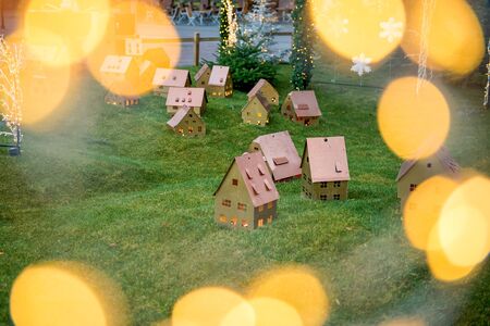 Small decorative wooden houses on lawn in christmas light Xmas decorations on main square in Strasbourg, Alsace, France. Little houses with light inside.の写真素材