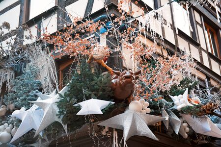 Christmas decorations with christmas trees, stars and deer on building in center of Strasbourg, France during xmas time. Capital of Christmas in Europe - atmosphere of holidays. Market in Europe.の写真素材