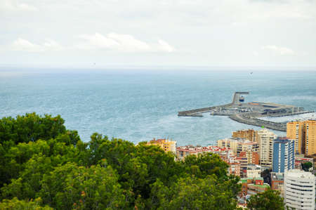 Aerial panoramic view of cityscape and harbour of Spanish city of Malaga, Costa del Sol, Spain, in spring cloudy day. Tourism travel destinationの写真素材