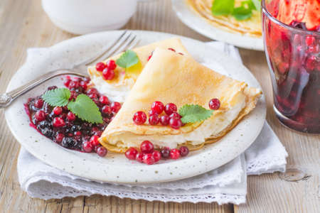 Pancakes with cream cheese with lingonberryの写真素材