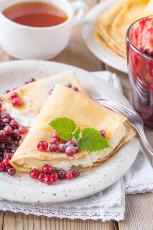 Pancakes with cream cheese with lingonberryの写真素材