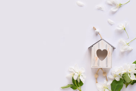 Apple blossom, birdhouse on white background. Flat lay, top view. Spring backgroundの写真素材