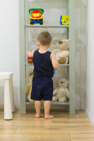 Cute little boy playing with toys in his room at home.の写真素材
